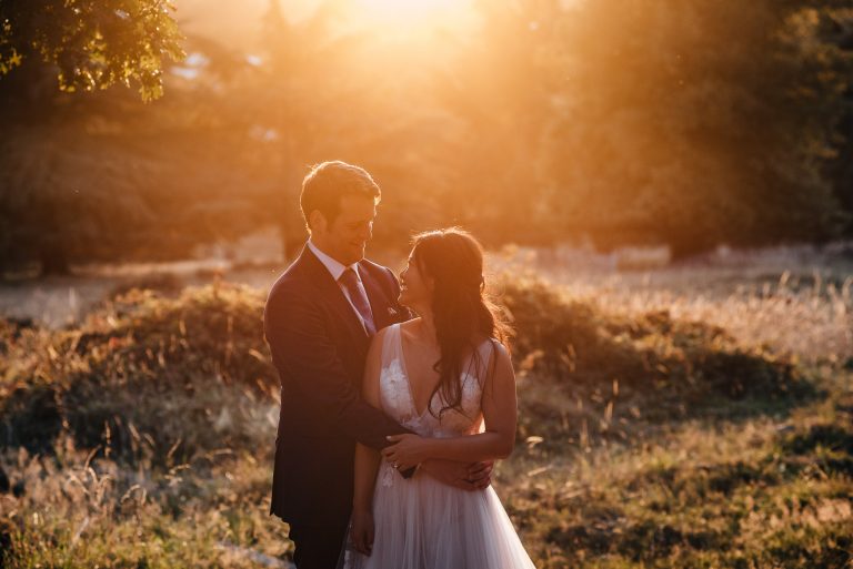 bride and groom hugging in sunset of richmond park