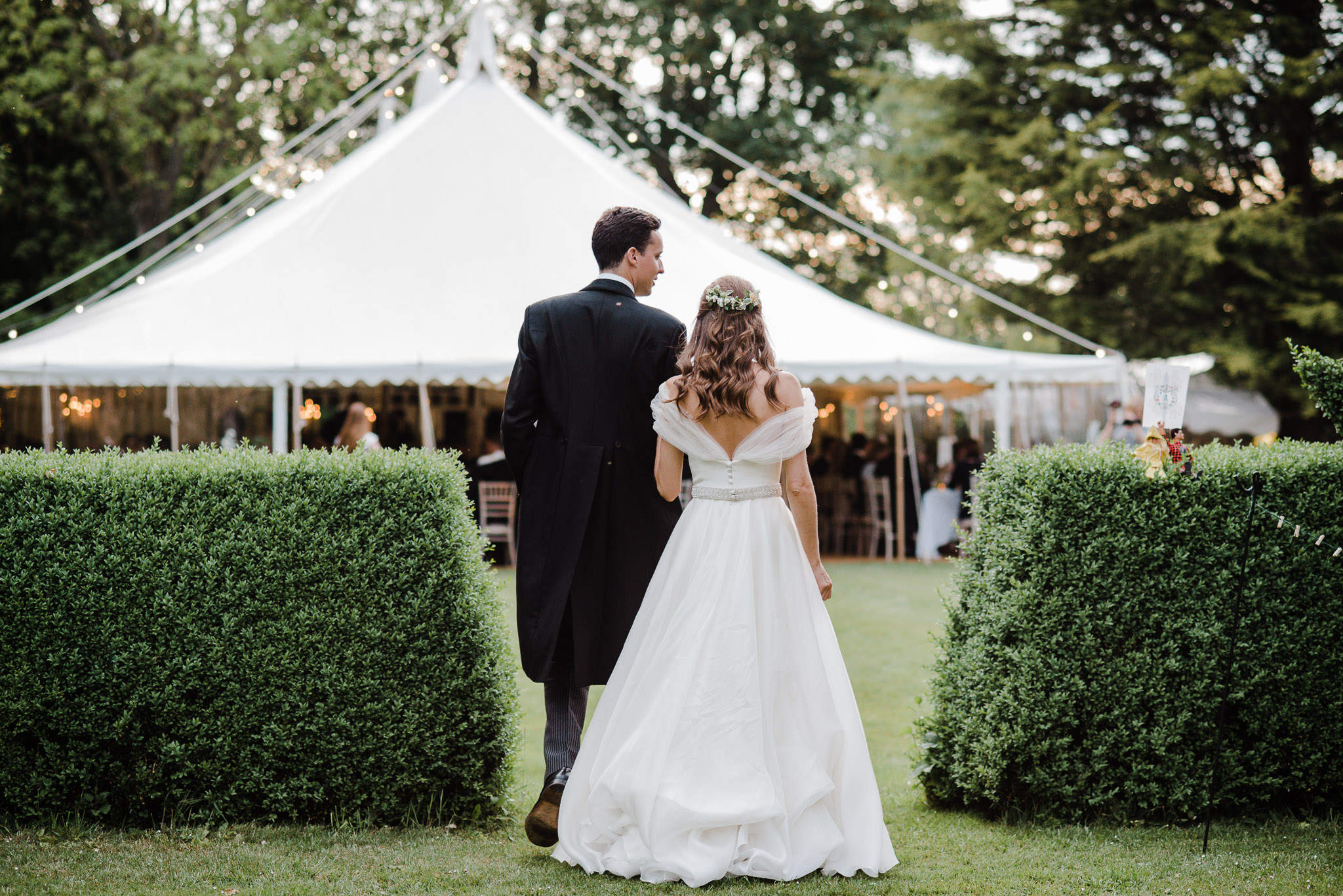 bride and groom walking into marquee