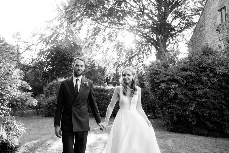 bride and groom holding hands
