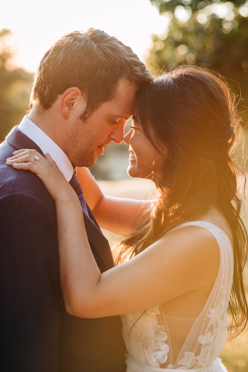 close-up of bride and groom going in for a kiss in sunset