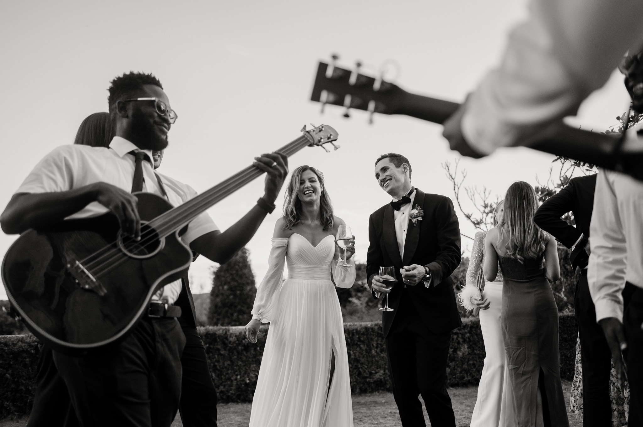 couple framed by musicians singing at their danesfield house wedding